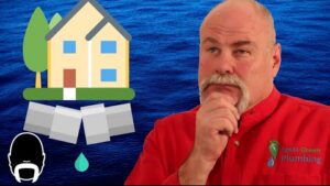 Plumber explaining how to identify the warning signs of a plumbing slab leak beneath a home's concrete foundation