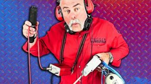 Plumber demonstrating slab leak detection equipment used to locate hidden water leaks beneath concrete foundations