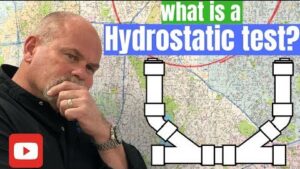Professional plumber explaining a hydrostatic plumbing test used to identify hidden sewer line leaks beneath a home's foundation